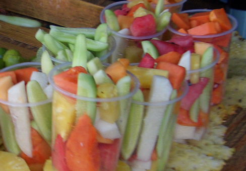 cut fruit and cucumbers in plastic cups in Mexico