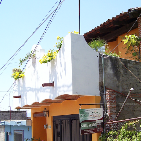 for sale sign, white veranda, yellow blossoms