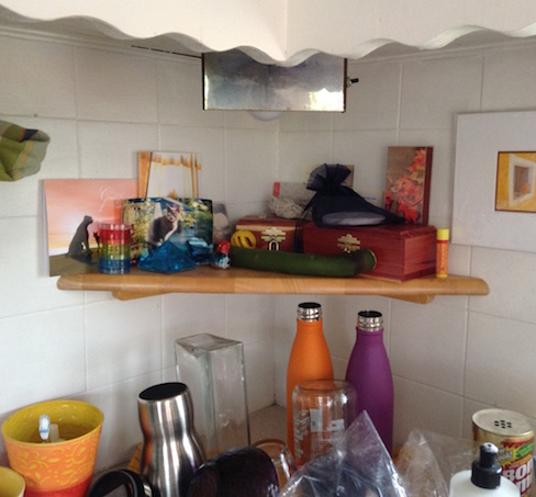 messy kitchen counter and small altar