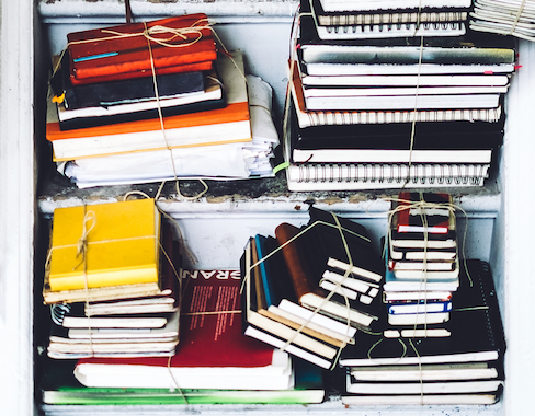 shelves of used notebooks tied in bundles